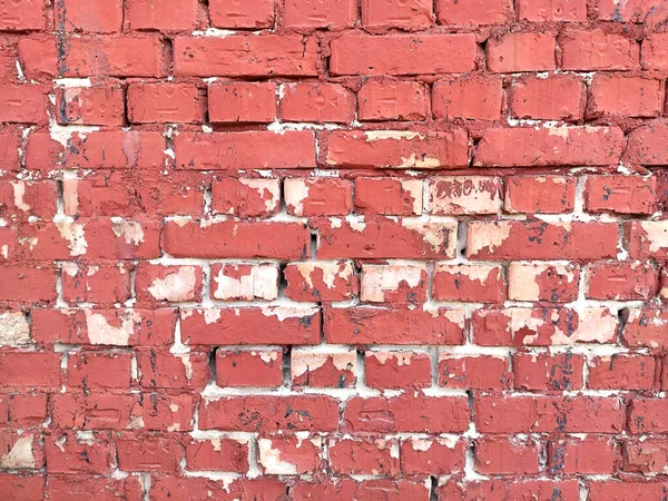 Colorful red brick wall on the house. Texture of red stone blocks, close up. Background. Old building.