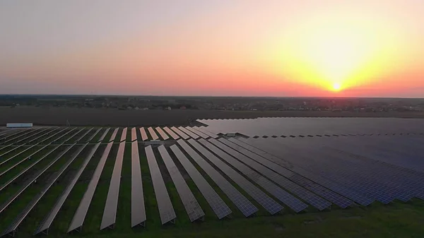 Large solar panels at a solar farm at summer sunset. Solar cell power plants. footage video 4k, aerial drone view