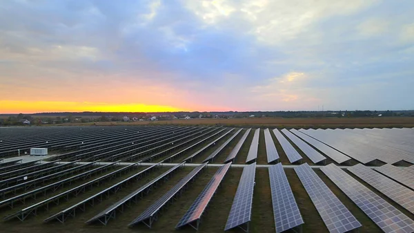 Large solar panels at a solar farm at summer sunset. Solar cell power plants. footage HDR video 4k, aerial drone view