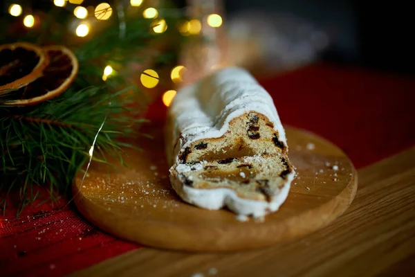 Stollen German christmas bread, Christmas stollen on wooden background, Traditional festive pastry dessert.