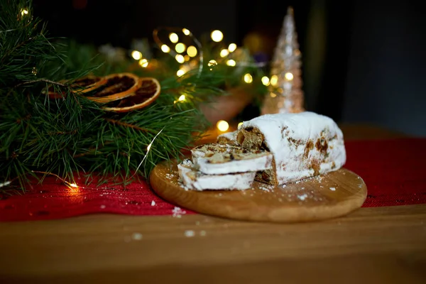 Stollen German christmas bread, Christmas stollen on wooden background, Traditional festive pastry dessert.