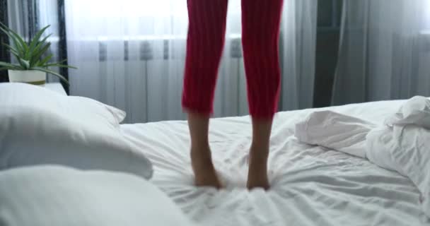 Unrecognizable Girl Having Fun Jumps Bed Child Leg Jumping White — Stockvideo