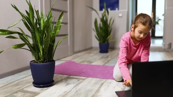 Little Girl Watching Online Video Laptop Doing Stretching Fitness Exercises — Stock Video