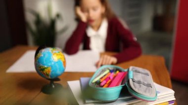 Sıkıcı liseli kız, masa başında oturup ödevlerini yapıyor, evde eğitim görüyor. Uzak öğrenimden bıkan küçük bir kız uzaktan eğitim alır ve sınavlara hazırlanır..