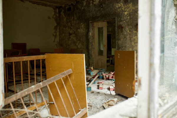 Broken, destroyd, abandoned kindergarten in Chernobyl Exclusion Zone, Lost toys, A broken plastic doll,  Ukraine, ghost town Pripyat
