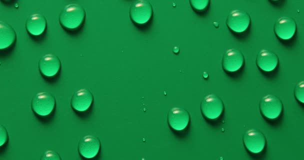 摘要水滴在绿色背景上 宏观上 气泡闭合 化妆品液滴 平铺图案上 — 图库视频影像