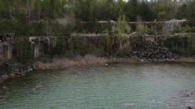 Hava aracı aile seyahati, Basalt sütunlarının manzarasına hayran olmak inanılmaz endüstriyel manzara, sel basmış bir taş ocağında zümrüt göl, açık maden. Göl ve Ukrayna 'ya giden bir maden ocağı.