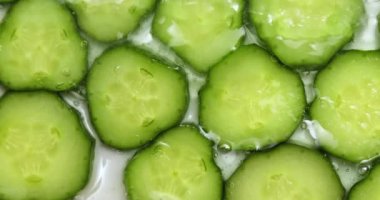 Rotation cucumber slices with gel on white background, natural medicinal plant for organic cosmetics, alternative medicine, health and beauty spa concept