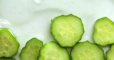 Rotation cucumber slices with gel on white background, natural medicinal plant for organic cosmetics, alternative medicine, health and beauty spa concept