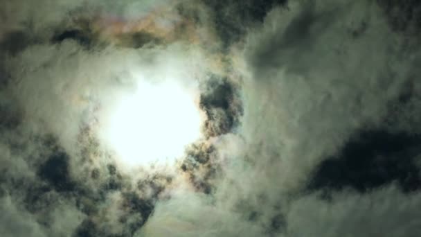 Weiße Wolken fliegen über eine Sonne, dunkles Licht, Wolkenzeitraffer Naturhintergrund — Stockvideo