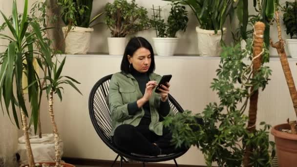 Woman Hold Mobile Phone Surfing Internet Type Message Sitting Armchair — Vídeo de Stock