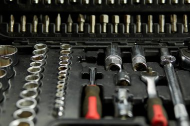 Open set box with working tools different types of metal steel heads and bits at the workshop, Interchangeable screwdriver set.