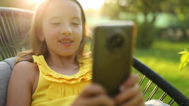 Happy Kid Girl Holding Smartphone Having Video Call Friend Distantly — Wideo stockowe