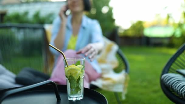 Happy Woman Glasses Talking Mobile Phone Sitting Chair Backyard Outdoor — Vídeo de Stock