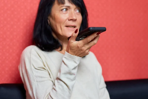 Senior Woman Sit Sofa Speak Microphone Dictate Audio Message Smartphone — Zdjęcie stockowe
