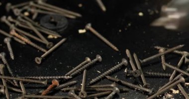 Man hands put drill and self-tapping screws, finished work, The choice of fasteners at the workshop or hardware store