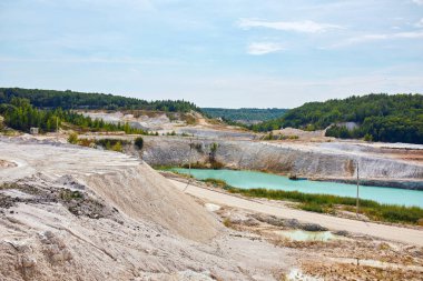 Quarry extraction porcelain clay, kaolin, with turquoise water and white shore, drone view open pit mine kaolin flooded with water, Ukraine