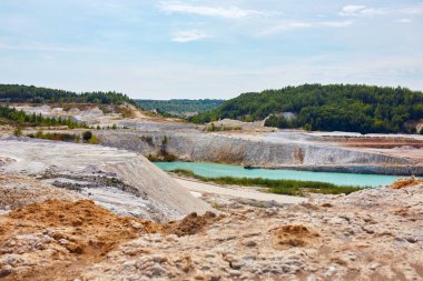 Quarry extraction porcelain clay, kaolin, with turquoise water and white shore, drone view open pit mine kaolin flooded with water, Ukraine