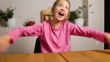 Emotional school girl vlogger speaking by video call blog talking to webcam at home, recording vlog kid using internet online video web application