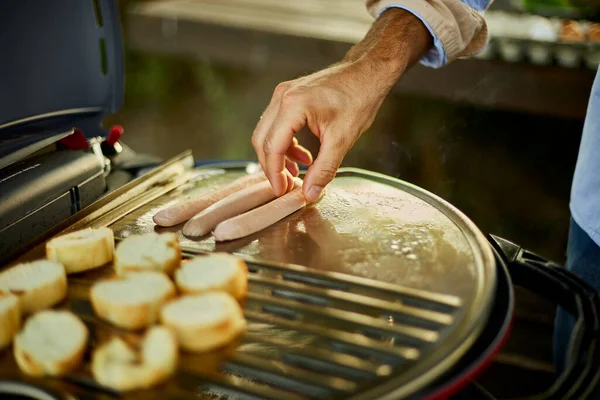 Close Man Hand Put Sausages Roasting Bruschetta Barbecue Gas Grill — Stok fotoğraf