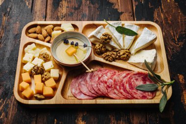 Şarap aperatifleri. Tahtada çeşitli peynirler..