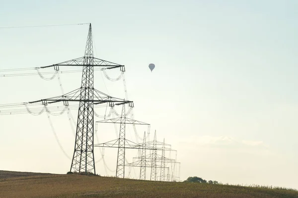 Electricity pylon for transmission and current transfer of high voltage through natural landscapes
