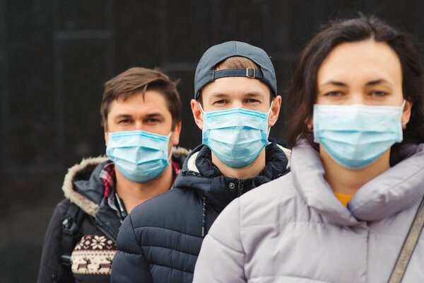 Crowd of people wearing medical masks. Coronavirus epidemic concept. Group of young volunteers outdoors. Coronavirus quarantine. Global pandemic. Worldwide coronavirus outbreak.