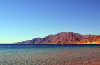 The view of Dahab lagoon in the background of distant mountains. The Sinai peninsula, Egypt.