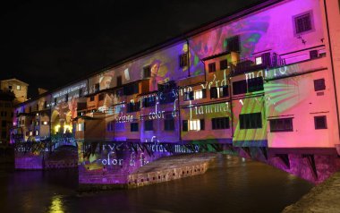 Floransa - Aralık 2020: Arno üzerindeki ünlü Ponte Vecchio, Noel tatili sırasında Floransa Işık Festivali vesilesiyle aydınlandı. İtalya.