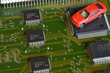 Elektronik panoda oyuncak arabalar ve mikroçip. Mikroçip ve yarı iletken sıkıntısı yeni araba sıkıntısı yaratıyor. Yarı iletken kıtlığı için kavramsal görüntü otomotiv endüstrisinin üretimini bozuyor.