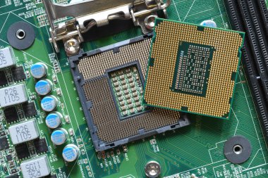 Detail of a CPU Processor over his Socket on a Motherboard. Printed Circuit Board - Computer Motherboard with Components. Close-up
