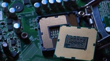 Detail of a CPU Processor over his Socket on a Motherboard. Printed Circuit Board - Computer Motherboard with Components. Shot with Rotation Movement