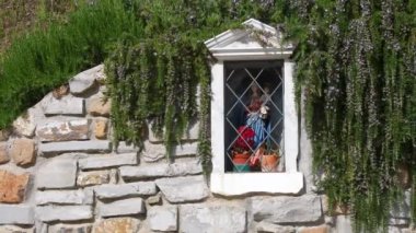 tabernacle on a stone wall and rosemary plant in the Tuscan countryside. Italy
