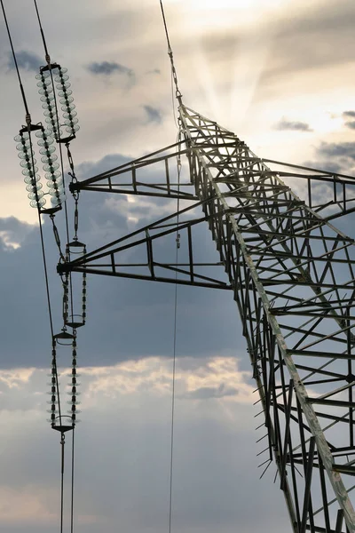 electric current trellis of a distribution line with insulators against cloudy sky