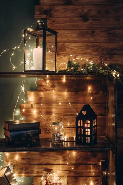 Winter decoration. decoration of the shelf for the new year or Christmas. candles, Christmas tree, books, bows and bumps — 图库照片