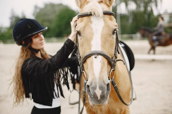 Portrait of riding horse with woman in black helmet — Stockfoto