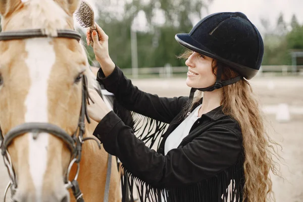 Portrait of riding horse with woman in black helmet with comb — Photo