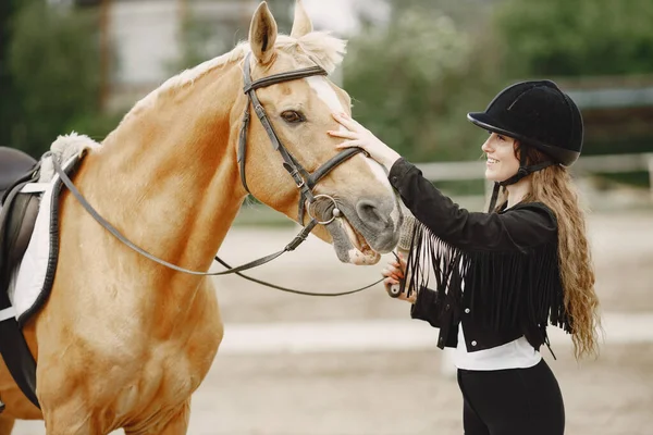 Portrait of riding horse with woman in black helmet with comb — Stockfoto