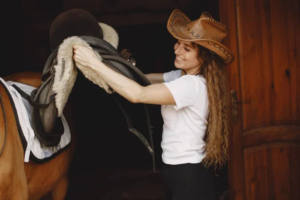 Portrait of rider woman with a brown horse in a stable —  Fotos de Stock