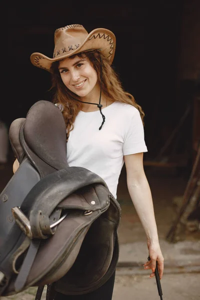 Portrait of rider woman in a leather hat in a stable — Photo