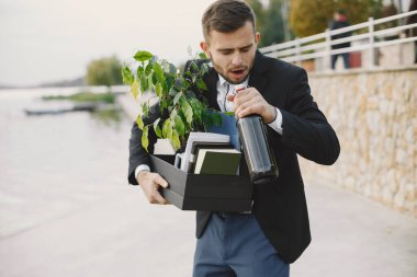 Upset fired european man getting drunk outside