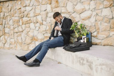Upset fired european man getting drunk outside