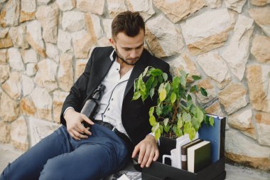 Upset fired european man getting drunk outside