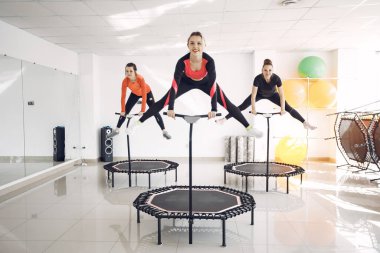 Jumping young women on a trampoline