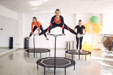Jumping young women on a trampoline