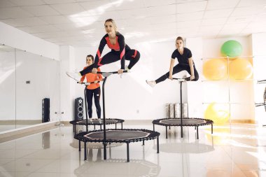 Jumping young women on a trampoline
