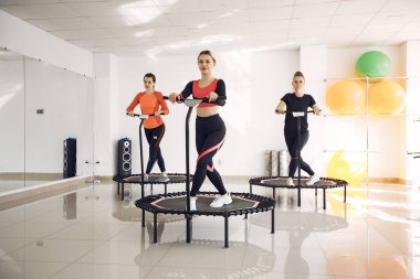 Jumping young women on a trampoline