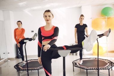 Jumping young women on a trampoline