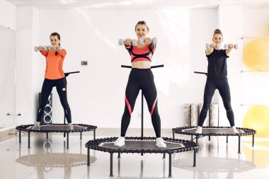 Jumping young women on a trampoline
