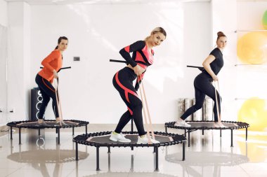 Jumping young women on a trampoline